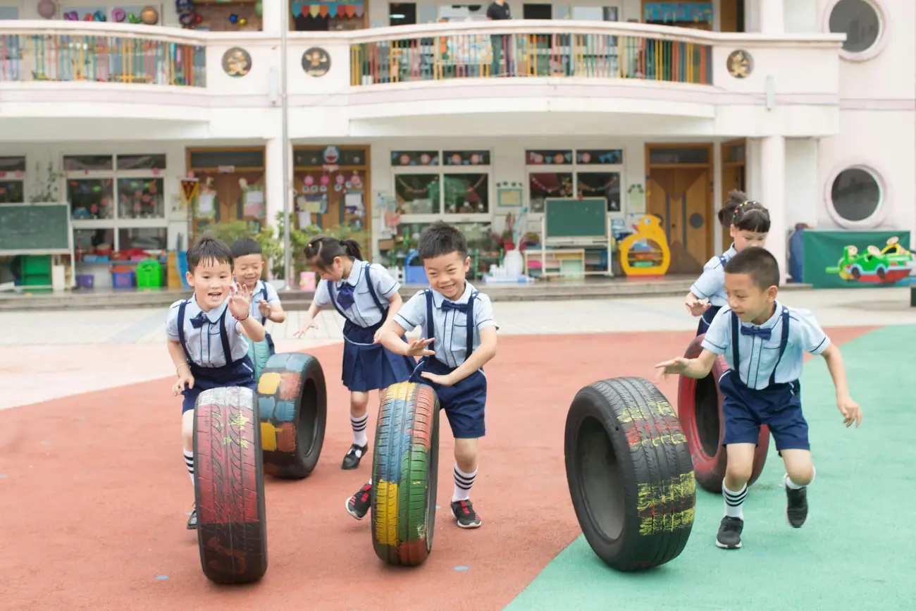 Children Playing with Tires in Schoolyard