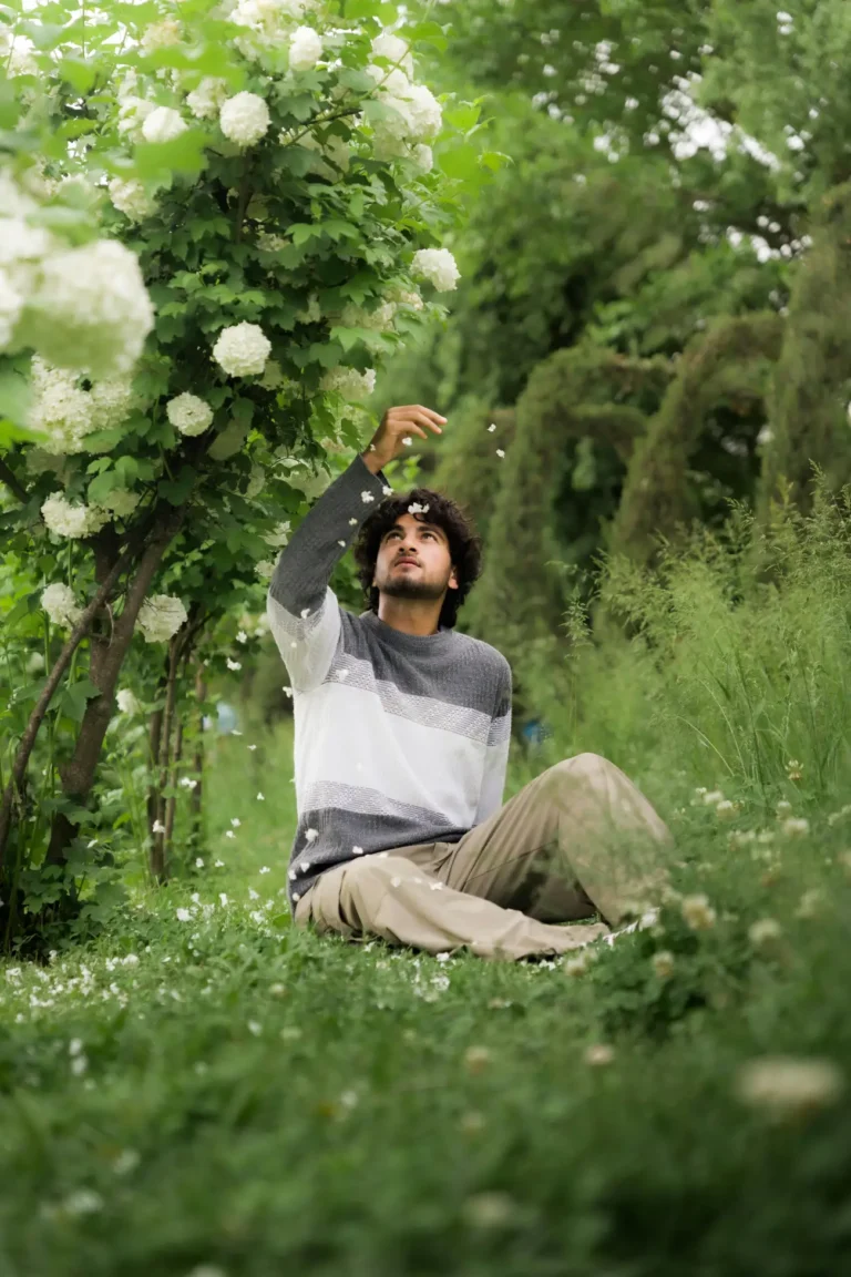 Man Enjoying Nature Among Blooming Flowers