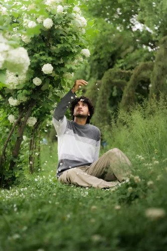 Man Enjoying Nature Among Blooming Flowers